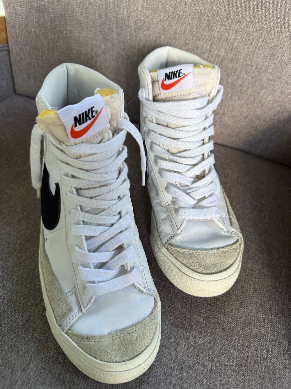 Nike White High-Top Sneakers with Black Swoosh and Orange Tongue Logo